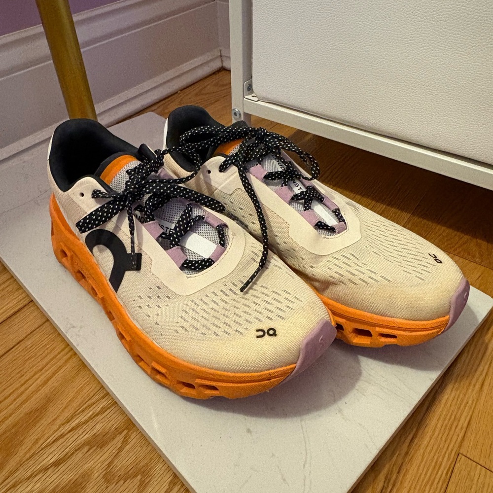 On Running Cream, Orange, and Lilac Athletic Shoes